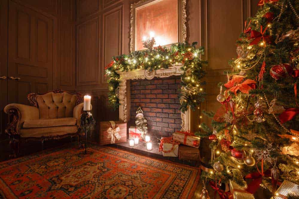 Christmas tree decoration in a room with a fireplace