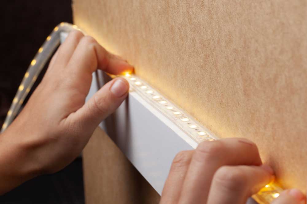 A person installing LED strip light