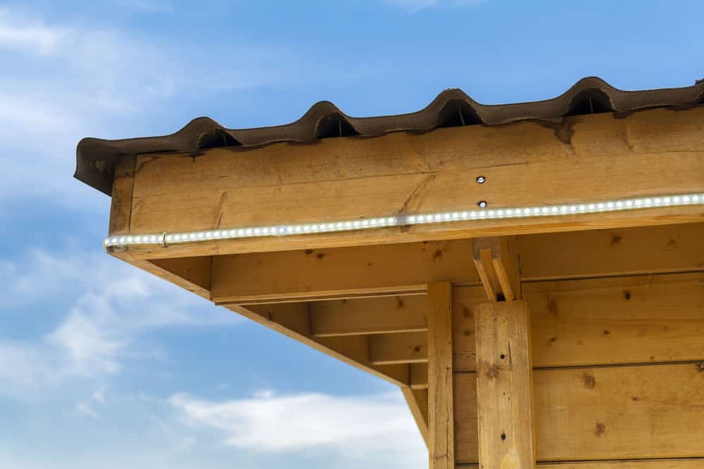 An outdoor LED strip light running around a kiosk