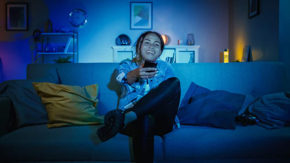 A smiling young girl in a room with wireless LED lights